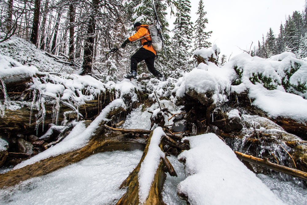 Covered in wet snow, slick rocks and fallen timber are nearly as treacherous as the avalanche prone slopes above.