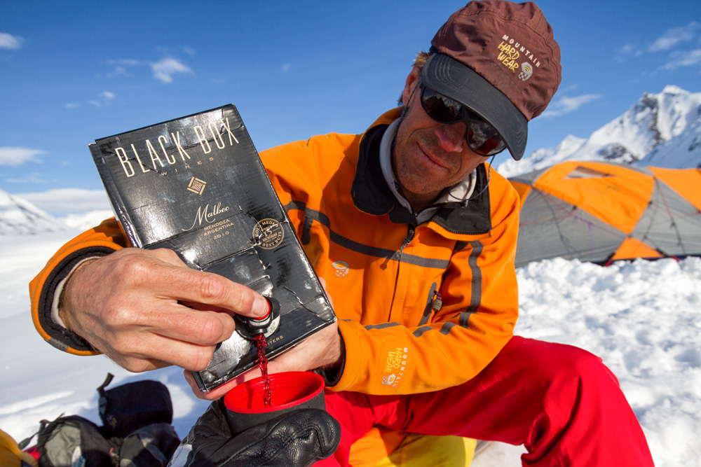 Andrew McLean pours and apres cocktail while expedition camping